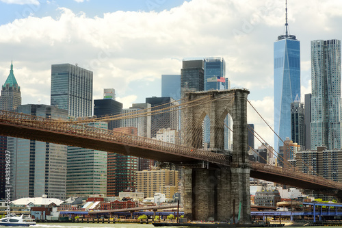 Famous Brooklyn bridge on the background of skyscrapers of Manhattan. Postcard view of New York, USA. United States of America landmarks. Sightseeing of NYC.