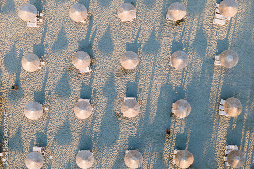 Aerial top view of umbrellas on the beach withot people, pattern view photo