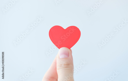 Female hand holding red heart. Organ donation, family insurance. World heart day, World health day, Gratitude, be kind, be thankful. Love concept.