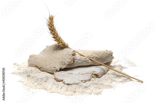 Barley flour pile and dough with wheat ear isolated on white background