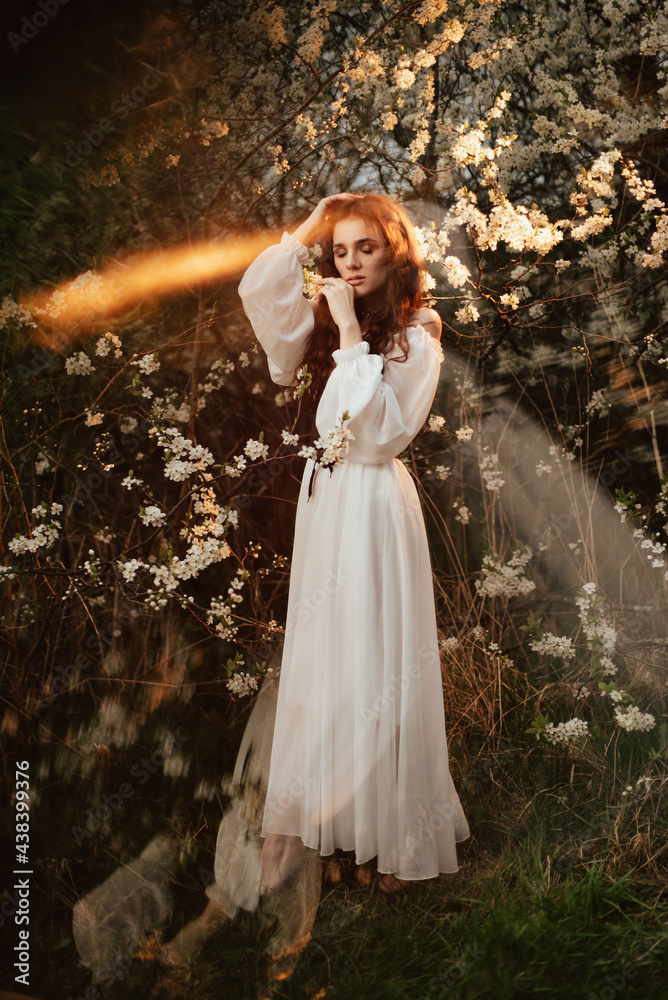 A full-length portrait of a romantic girl, looking like a forest fairy, in a blooming garden with elements of phantasmagoria. The concept of fantasy, fairy tales. A full-length portrait of a romantic girl, looking like a forest fairy, in a blooming garden with elements of phantasmagoria. The concept of fantasy, fairy tales.