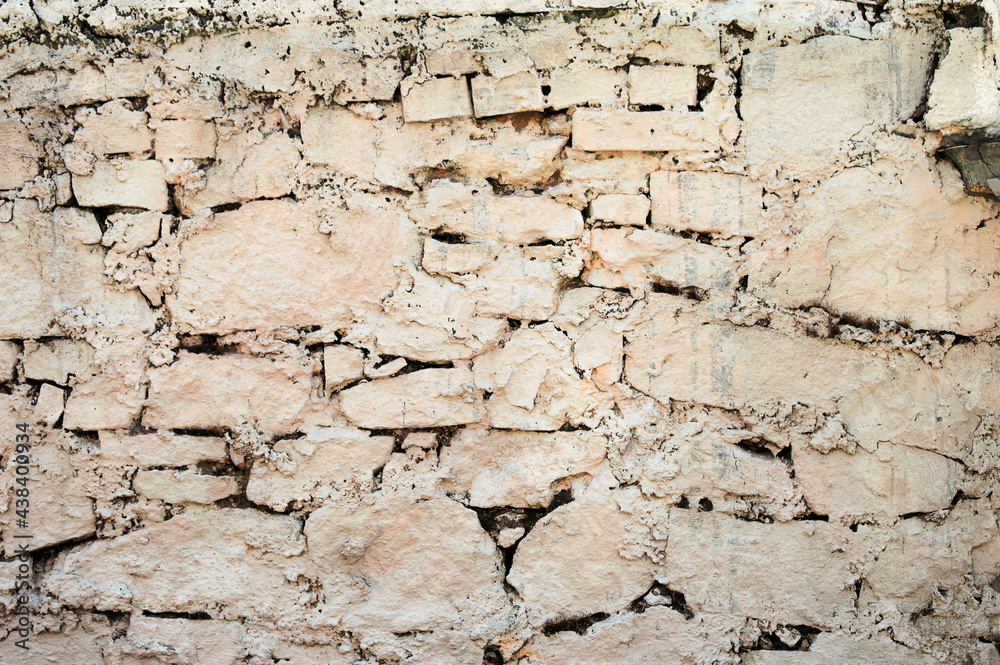 Ancient stone wall. Ruin. Gray stone background. Wall with peeling plaster. Ancient stone wall. Ruin. Gray stone background. Wall with peeling plaster.