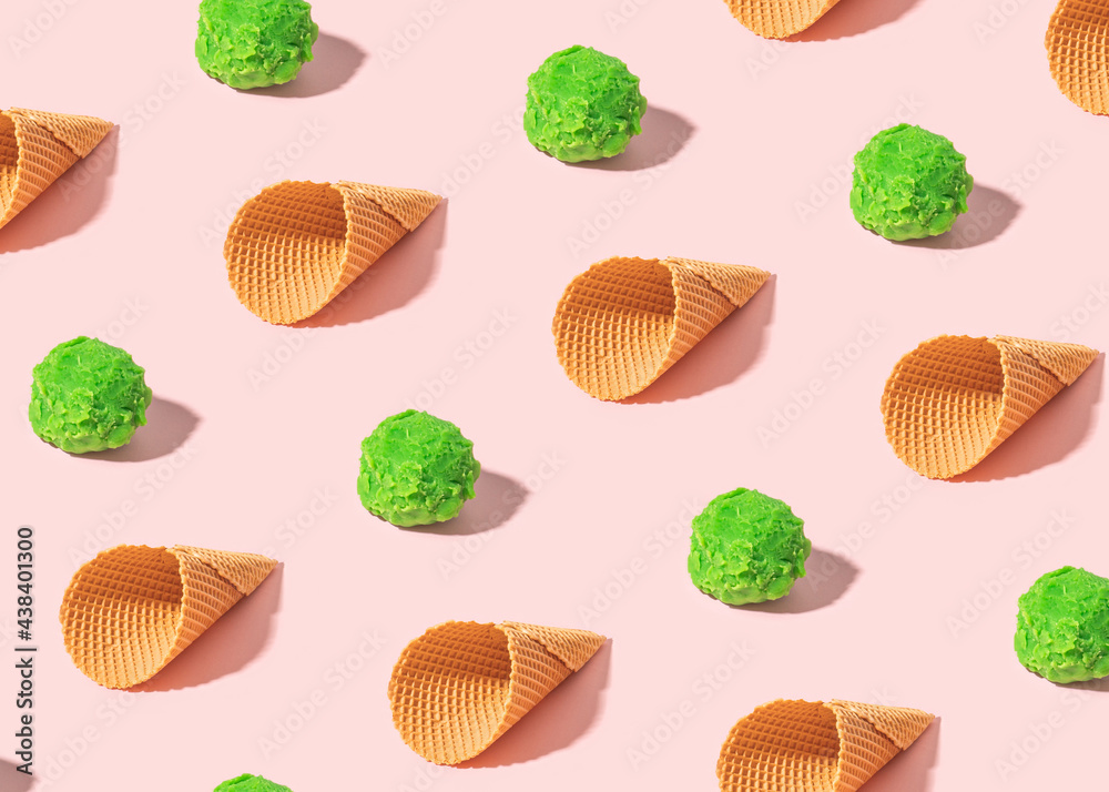 Naklejka premium Creative summer pattern with green ice cream scoops and cones on sunny pink background. Minimal summer food concept.