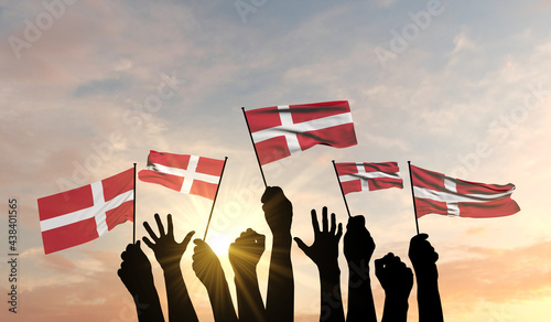 Silhouette of arms raised waving a Denmark flag with pride. 3D Rendering