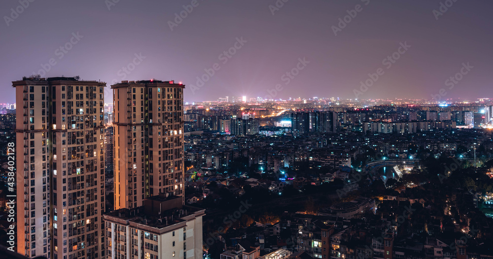 Fototapeta premium Long exposure night view on tall skyscrapers residential district buildings, city background. Beautiful night view cityscape of Chinese metropolis Chengdu.