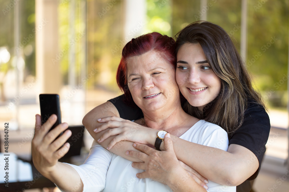 mother and daughter selfie with mobile smart phone. Happy family online photo sharing for social media. fun People parents and technology lifestyle concept.
mother and daughter selfie with mobile smart phone. Happy family online photo sharing for social media. fun People parents and technology lifestyle concept.