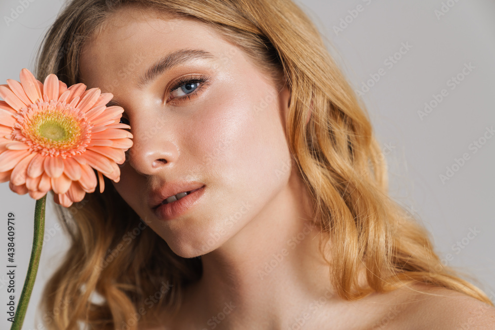 Half-naked ginger woman posing with gerbera flower Half-naked ginger woman posing with gerbera flower