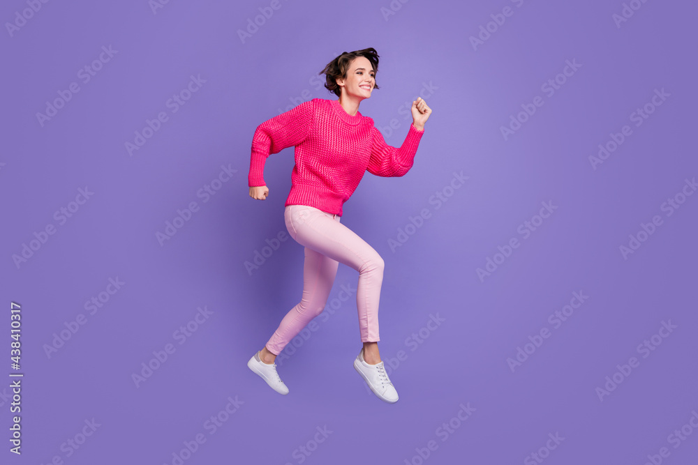Full length profile side photo of young girl happy smile jump go run speed hurry sale isolated over violet color background