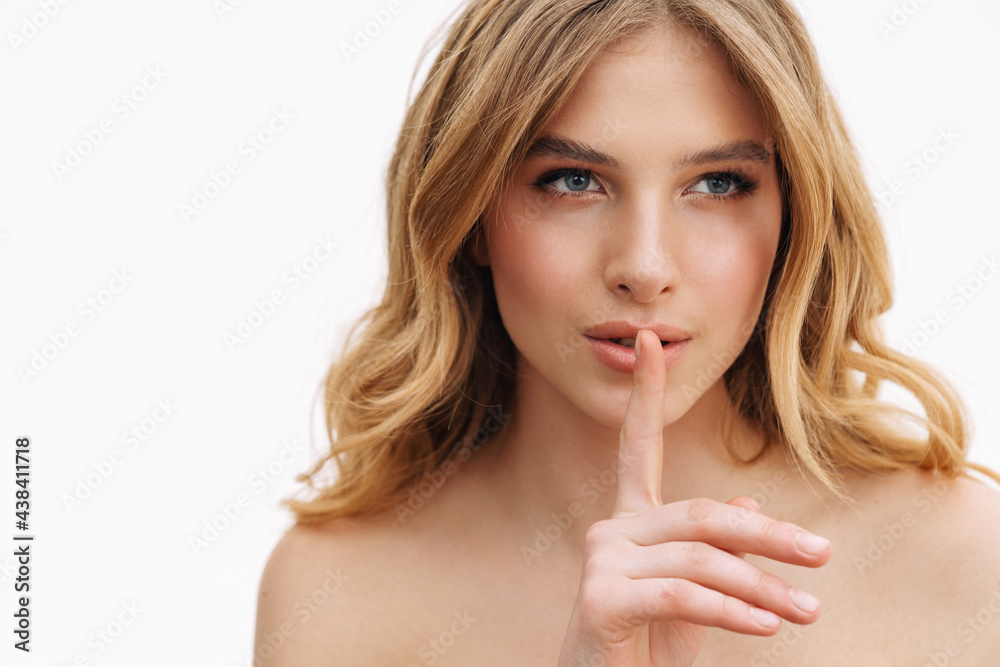 Half-naked blonde woman showing silence gesture at camera Half-naked blonde woman showing silence gesture at camera