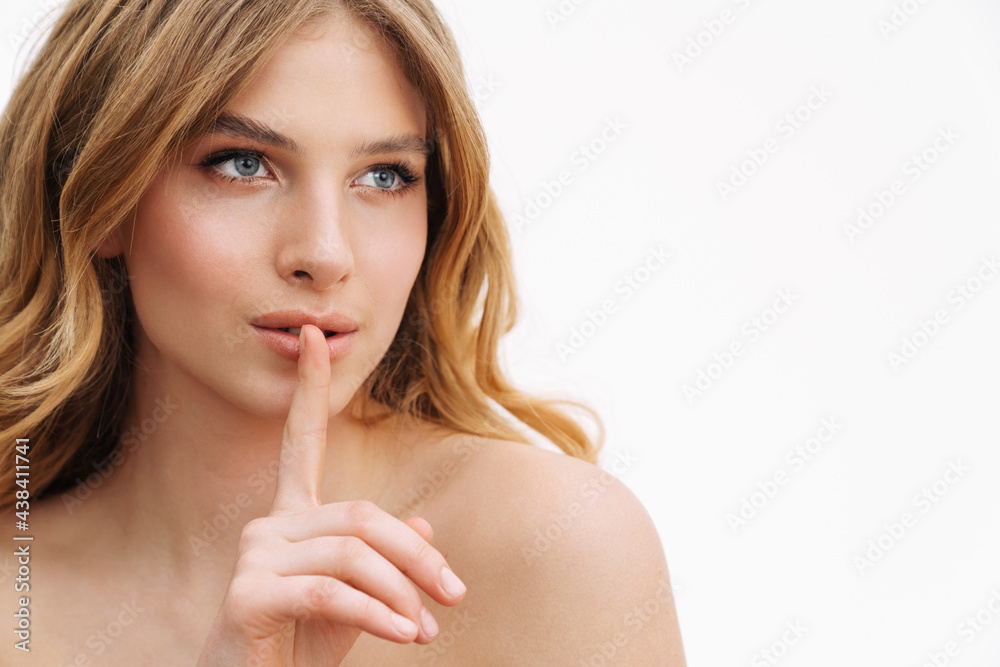 Half-naked blonde woman showing silence gesture at camera Half-naked blonde woman showing silence gesture at camera