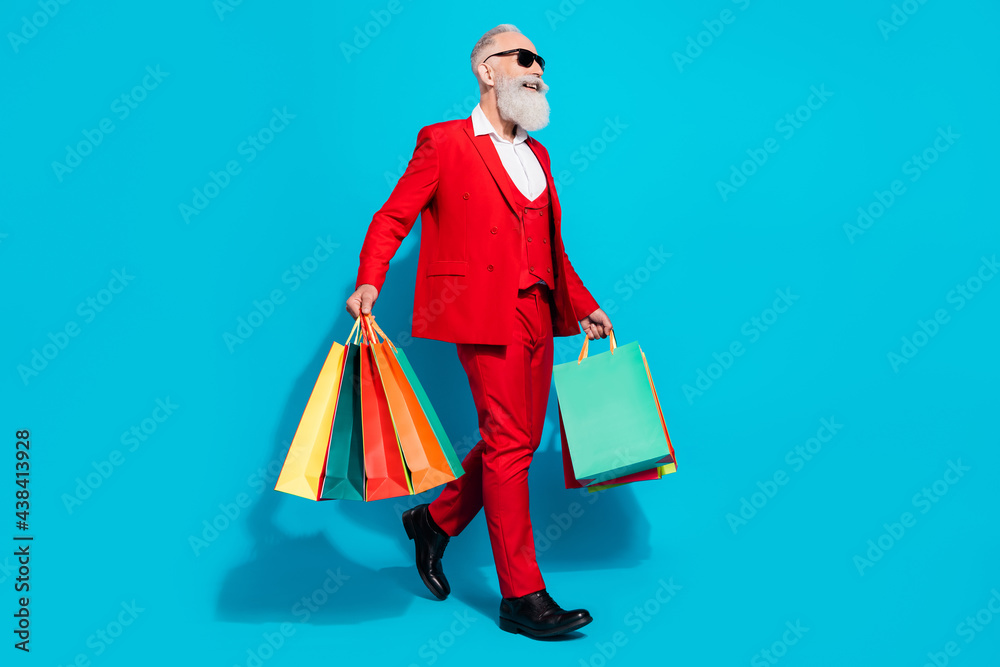 Full length body size photo aged man keeping bags shopping mall walking forward isolated vivid blue color background