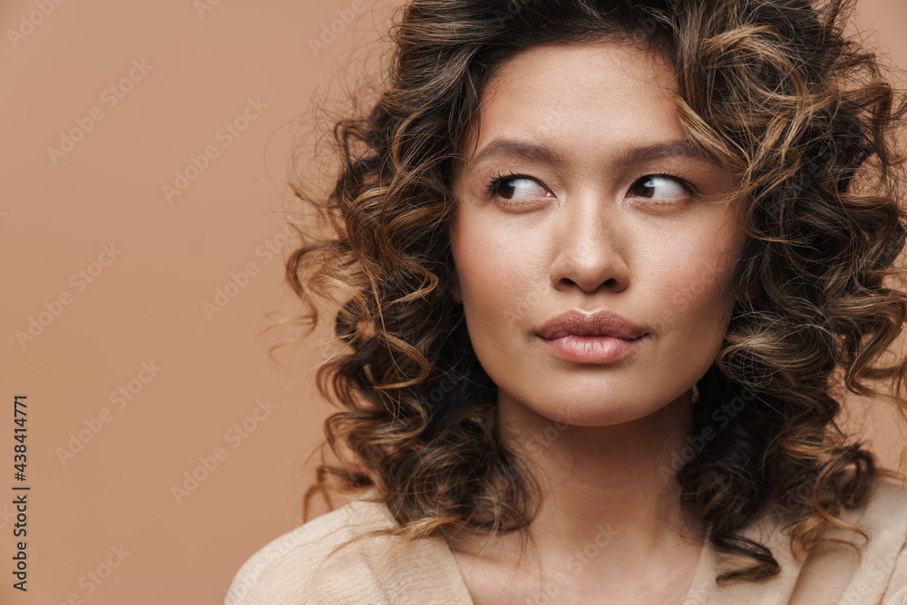 Young curly hispanic woman posing and looking aside Young curly hispanic woman posing and looking aside