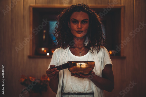 Slika na platnu Spiritual girl immersed in meditative sounds of tibetian bowl.