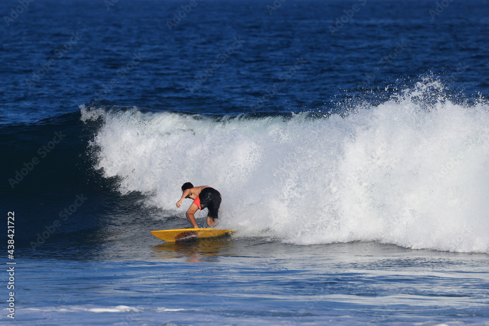 Surfers ride the waves in Bali, Indonesia during summer vacation Surfers ride the waves in Bali, Indonesia during summer vacation