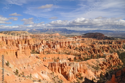 Panoramic view of huge rocky terrain, pinnacles and cliffs under cloudy sky in Paunsaugunt Plateau of Bryce Canyon National Park, USA