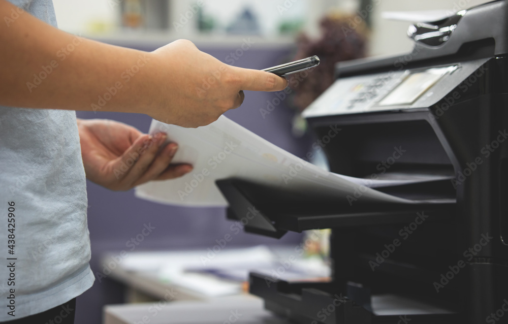 Fotka „Office workers print documents from mobile phones. the printer