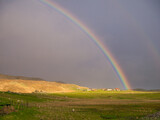 Sunlight and rain giving a bright rainbow at Westing on the island of Unst in Shetland.