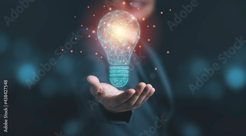 Businessman holding drawing glowing lightbulb, creative thinking ideas and innovation concept. photo