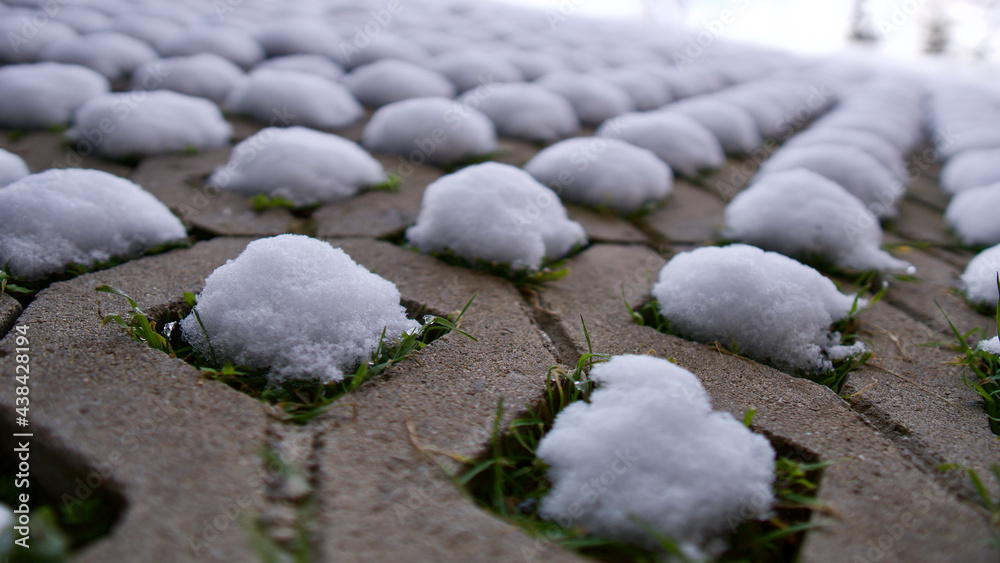 Heaps of snow on the perforated garden stone. snow puddle. Heaps of snow on the perforated garden stone. snow puddle.