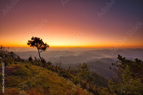 Mountain view misty morning of the hill around with the mist in valley with yellow sun light and cloudy sky background, sunrise at Phu chi phur viewpoint ,Mae Hong Son Northern, Thailand.
