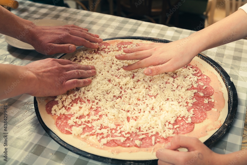 Preparing pizza for baking in the oven. Preparing pizza for baking in the oven.