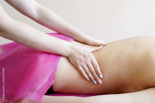 Young woman receiving a back massage in a spa center