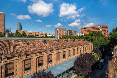 A view of area of Poblenou, old industrial district converted into new modern neighbourhood with trees and parks in coastal zone of Barcelona, Spain photo