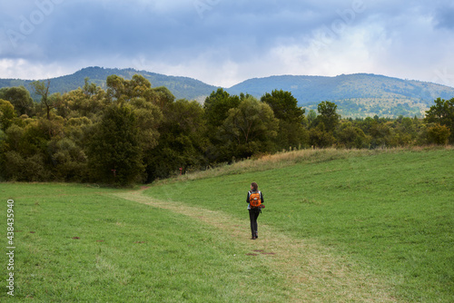 A woman trekking in the nature during the summer season © Marko