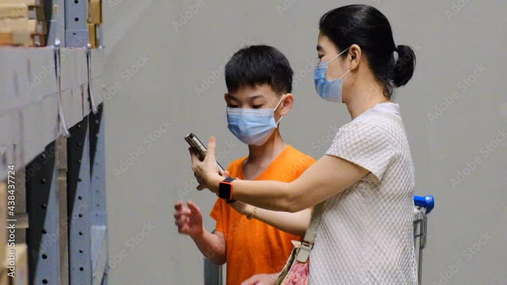Asian mother and son buying online building materials shop during pandemi