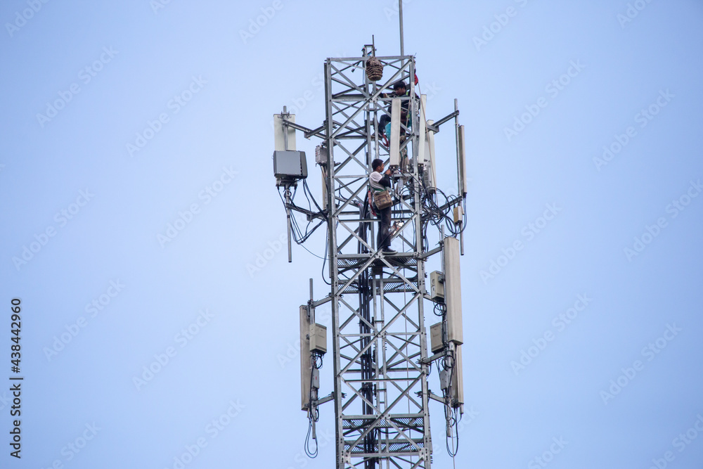 transmitter atop a cell phone pole About to be upgraded from 4g to 5g. High-risk electrical engineer job in Thailand.