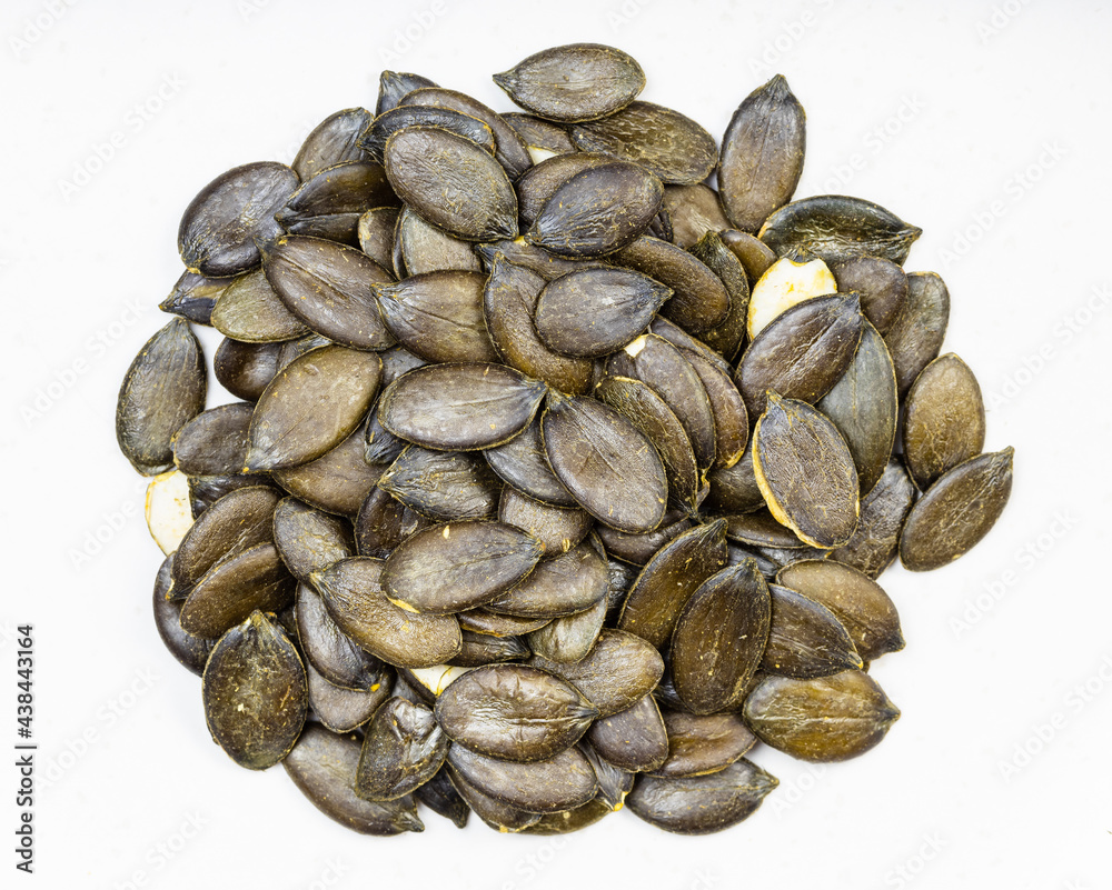 pile of styrian pumpkin seeds close up on gray pile of styrian pumpkin seeds close up on gray