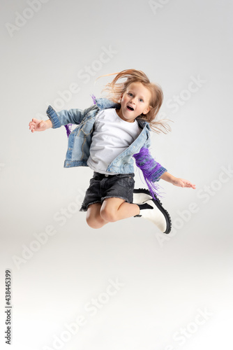 Caucasian girl isolated on white studio background. Copyspace. Childhood, education, emotions concept