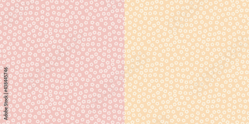 Seamless ditsy pattern of small flowers in pink and yellow variations. 