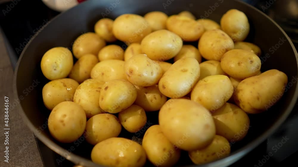 young potatoes in a pan. frying fresh potatoes young potatoes in a pan. frying fresh potatoes