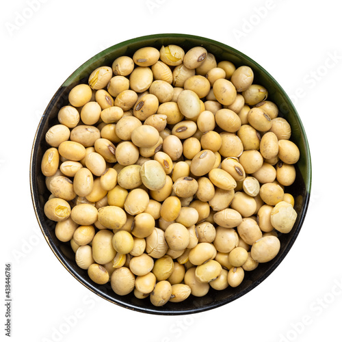 raw dried soybeans in round bowl isolated