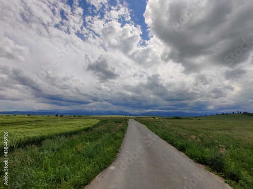 Road in the field with clouds