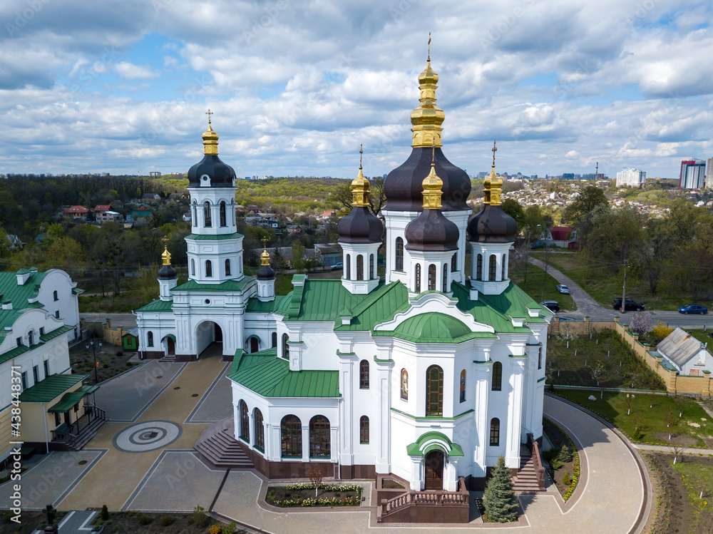 Orthodox church on the outskirts of the forest. Aerial drone view.