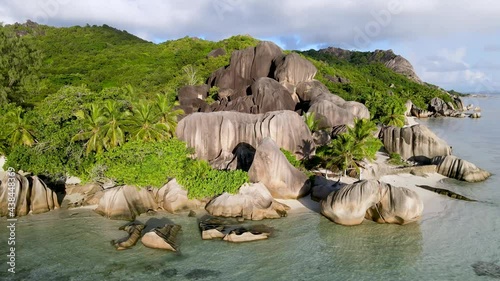 Beach Anse Source d'Argent in La Digue island, Seychelles. Paradise holiday vacation destination, scenic landscape with turquoise sea water and white sand. Aerial drone video footage 4k 60fps