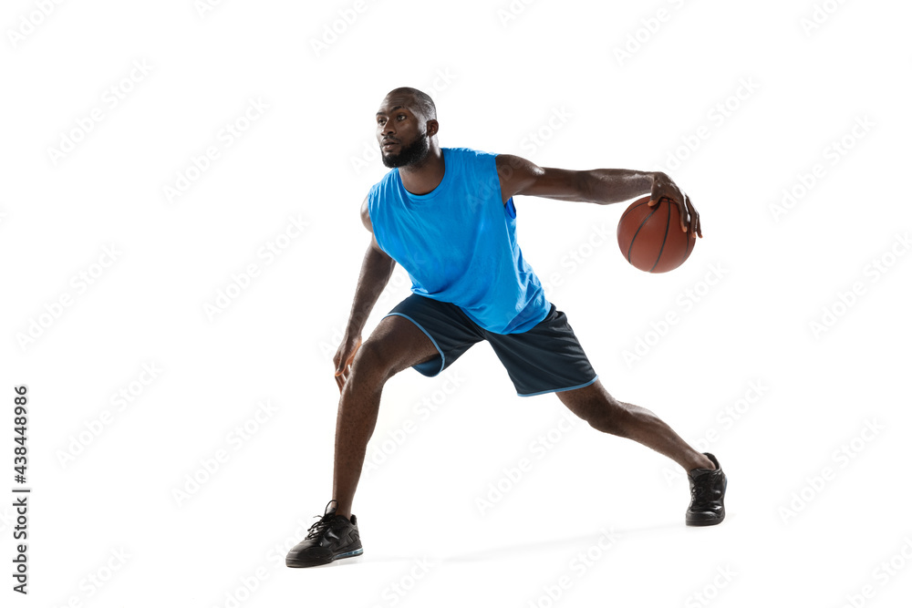 Full length portrait of a basketball player with a ball isolated on white studio background. advertising concept. Fit african american athlete jumping with ball.