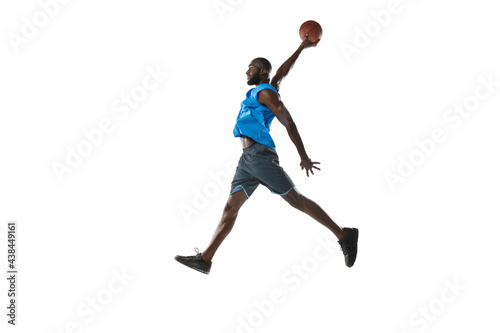 Full length portrait of a basketball player with a ball isolated on white studio background. advertising concept. Fit african american athlete jumping with ball. © master1305