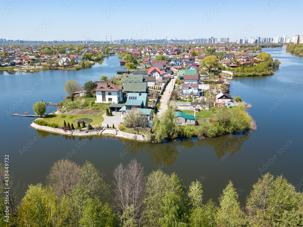 Fototapeta premium River in a suburban village. Aerial drone view.