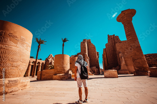 A male tourist stands at the entrance to Karnak Temple, Luxor, Egypt. photo