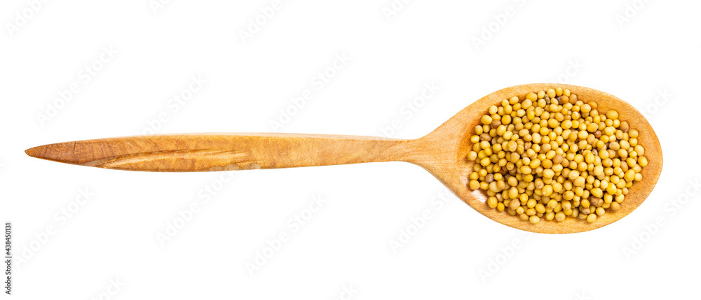 top view of wood spoon with yellow mustard seeds top view of wood spoon with yellow mustard seeds