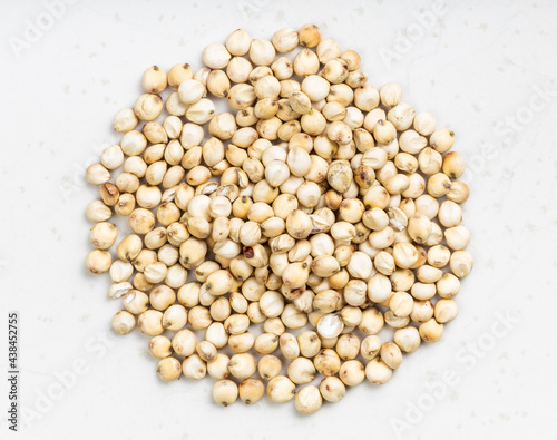Bild auf Leinwand pile of raw unpolished Sorghum grains on gray