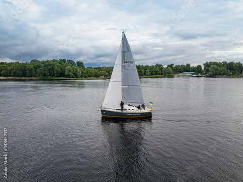 Sailing yacht floats on the river. Aerial drone view.