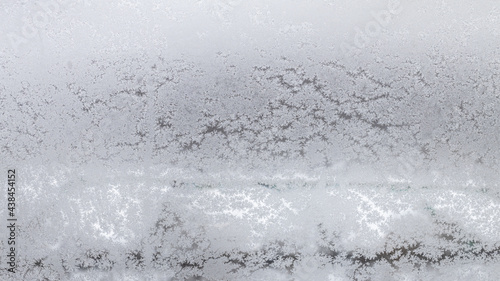 frosted home window in urban houses in winter photo