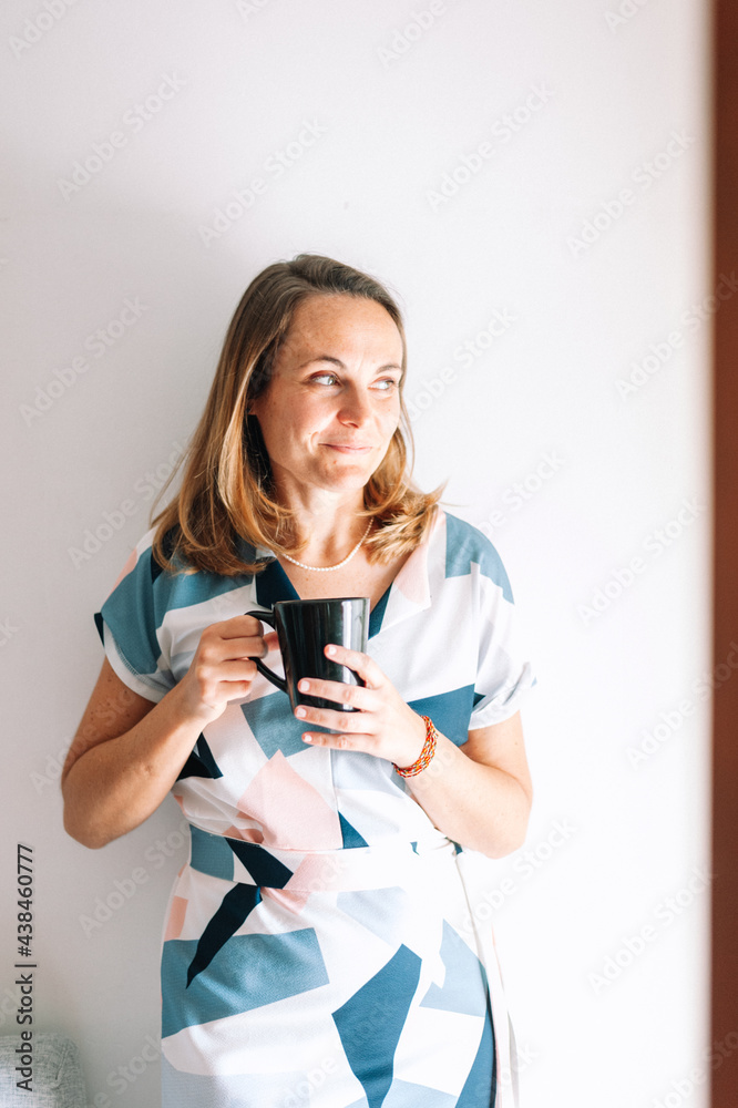Young adult woman having coffee at home Young adult woman having coffee at home