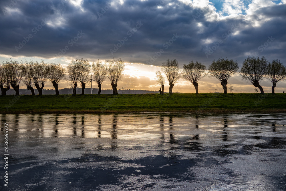 Fototapeta premium Country landscape on river at sunset, Germany