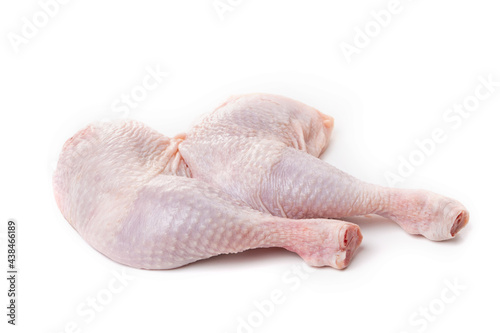 Raw chicken thighs with skin on a white background.