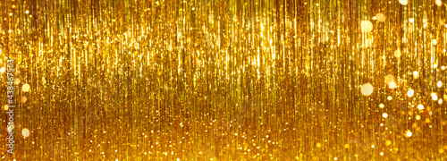 Festive gold tinsel glitters. Web banner, background for your design photo